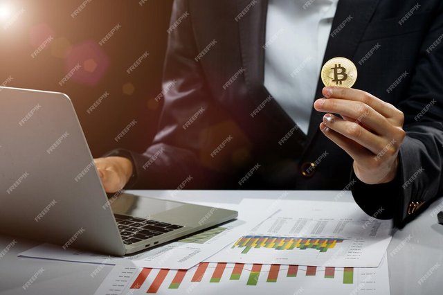 business-woman-hold-bitcoin-cryptocurrency-actual-coin-hand-present-decentralized-finance-mockup-copy-space-black-background-with-computer-laptop-chart-table_121764-5300.jpg