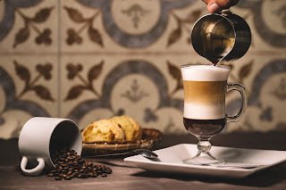 barista-pouring-syrup-into-layered-latte (1).jpg