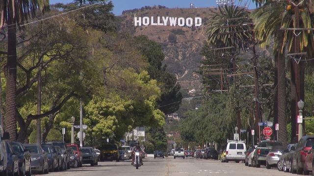 hollywood-sign-and-traffic-street-by-day-palm-tree-los-angeles-la-california-_editorial-footage_b1irpnc__F0000.png