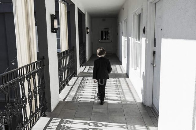 focused_353830062-stock-photo-year-old-boy-walking-corridor.jpg