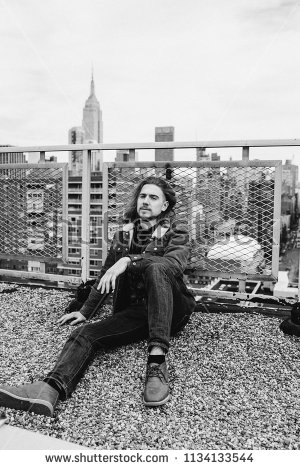 stock-photo-bearded-hipster-sitting-on-rooftop-in-new-york-city-manhattan-usa-black-and-white-photo-1134133544.jpg