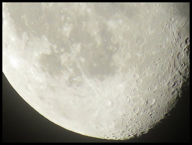 real close up of the moon showing lots of details of the surface of the moon.JPG