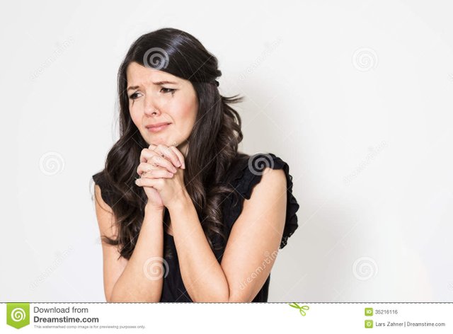 distraught-tearful-young-woman-her-hands-clasped-anguish-standing-downcast-eyes-against-white-studio-background-35216116.jpg