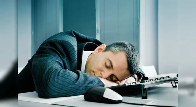 68ad06f1-Businessman-sleeping-at-desk.webp