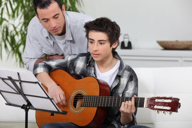 boy-learning-to-play-the-guitar.jpg
