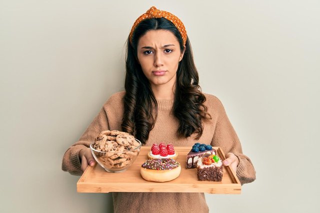 young-hispanic-woman-holding-tray-with-pastries-breakfast-skeptic-nervous-frowning-upset-because-problem-negative-person_839833-9785.jpg