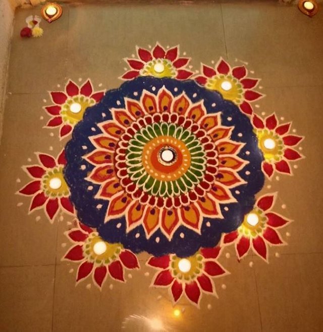 Beautiful Rangoli Kolam with Diyas.jpg