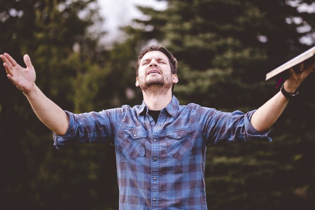 young-male-speaking-holding-bible-his-hands.jpg