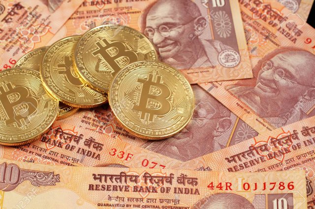 92646889-a-close-up-image-of-bitcoins-with-indian-rupee-notes.jpg