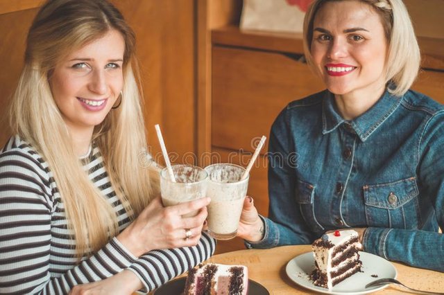 two-happy-women-sitting-cafe-drink-cocktail-tell-each-other-funny-stories-being-good-mood-laughing-happily-best-friends-143431378.jpg