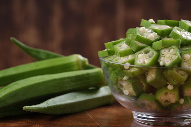 okra-ladys-finger-bhindi-fresh-green-vegetable-arranged-wooden-board-with-glass-bowl-full-okra-sliced-rings-with-wooden-background-selective-focus_527904-3169.jpg