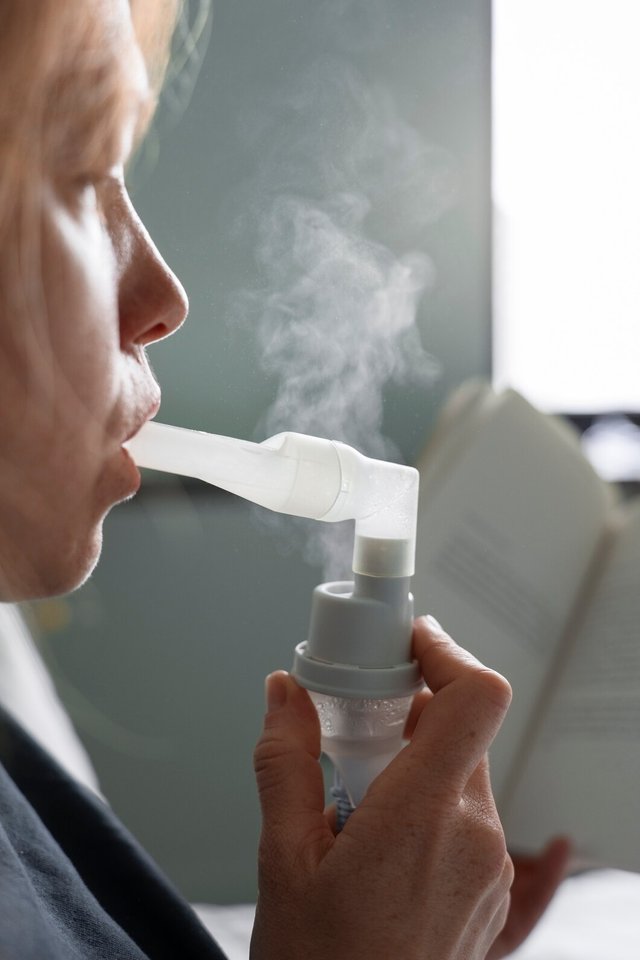 side-view-woman-using-nebulizer-home_23-2150562053.jpg