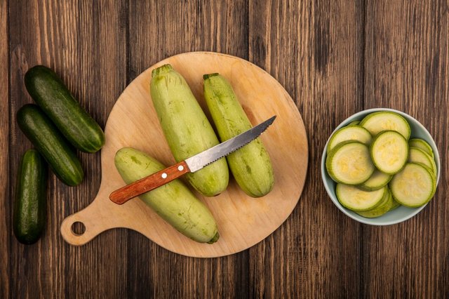 top-view-zucchinis-isolated-wooden-kitchen-board-with-knife-with-cucumbers-isolated-wooden-surface_141793-81343.jpg