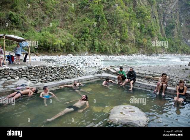 trekkers-relaxing-at-hot-springs-tatopani-village-annapurna-circuit-APTMEK.jpg