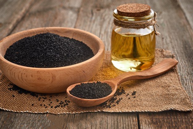 black-cumin-seeds-wooden-spoon-bowl-with-bottle-oil-wooden-table_179369-438.jpg