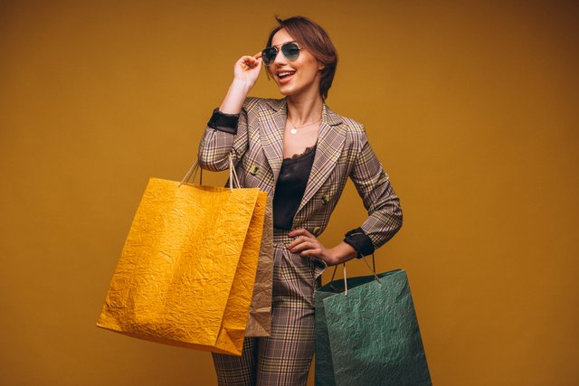 woman-with-shopping-bags-studio-yellow-background-isolated.jpg