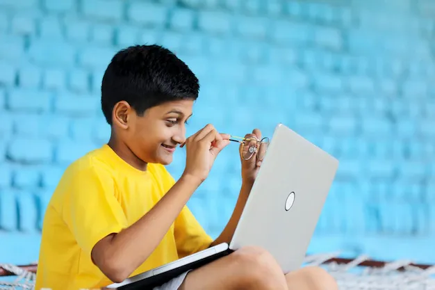 indian-child-using-laptop-home-attending-online-classes_54391-5052.webp