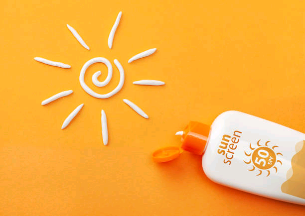 sunscreen-on-orange-background-plastic-bottle-of-sun-protection-and-white-sun-shaped-cream.jpg