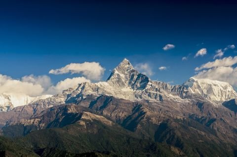 snow-capped-mountain-peak-surrounded-by-clouds-on-royalty-free-image-1623254319.jpg