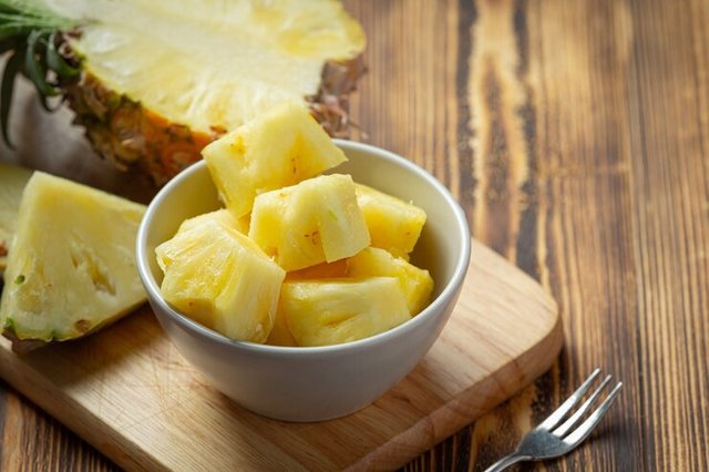 fresh-pineapple-dark-wooden-surface_1150-42291.jpg