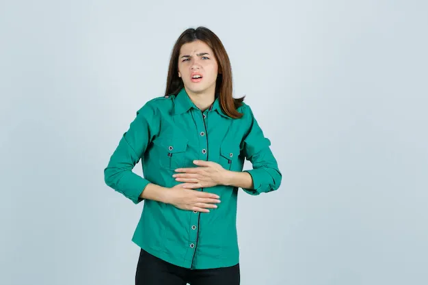 beautiful-young-lady-green-shirt-feeling-stomach-pain-looking-unwell-front-view_176474-66269.webp