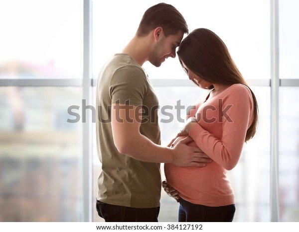 pregnant-woman-husband-front-window-600w-384127192.jpg