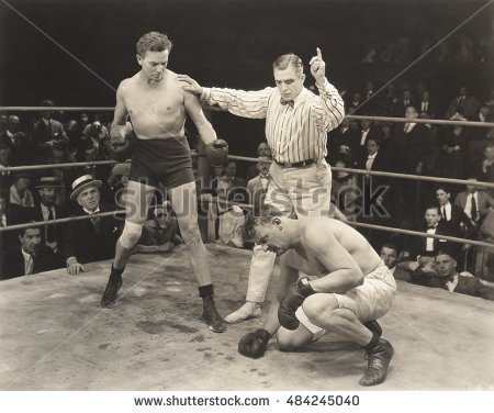stock-photo-referee-counting-over-boxer-in-ring-484245040.jpg