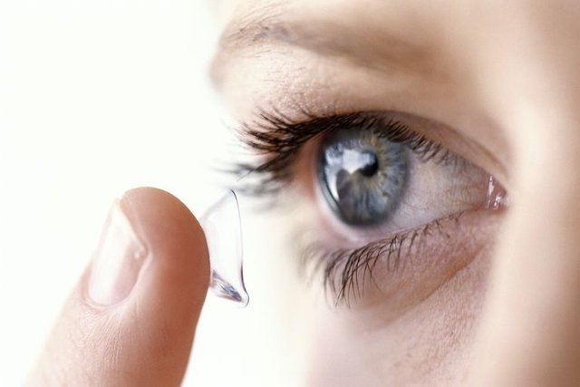 young-woman-putting-contact-lens-in-eye-high-res-stock-photography-10167238-1564409412.jpg