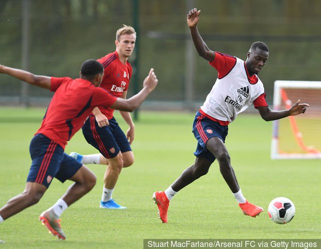 lr_rob_holding_and_nicolas_pepe_of_arsenal_during_a_training_ses_1290217.jpg