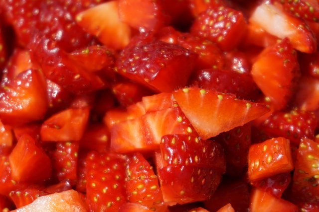 Close-up of piled small cut strawberry pieces.