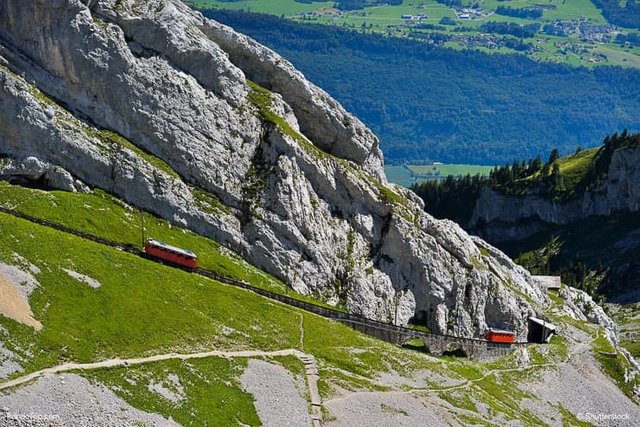 The-two-red-Pilatus-train-the-worlds-steepest-cogwheel-railway-nears-the-top-of-Mount-Pilatus.jpg