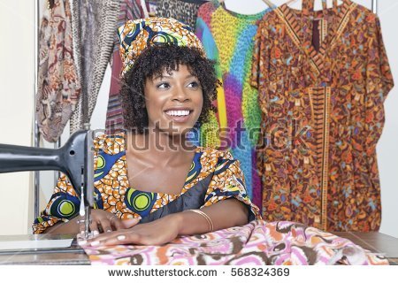 stock-photo-beautiful-african-american-female-tailor-looking-away-while-stitching-cloth-on-sewing-machine-568324369.jpg
