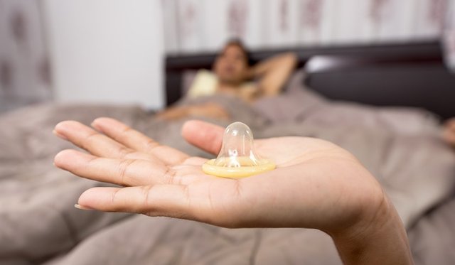 close-up-of-woman-holding-condom-248148.jpg