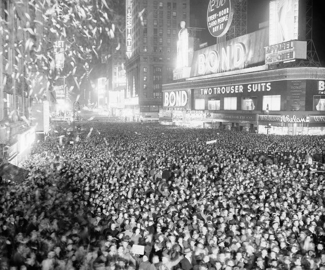 a-crowd-rings-in-the-new-year-on-january-1st-1938-at-broadway-and-seventh-avenue.jpg
