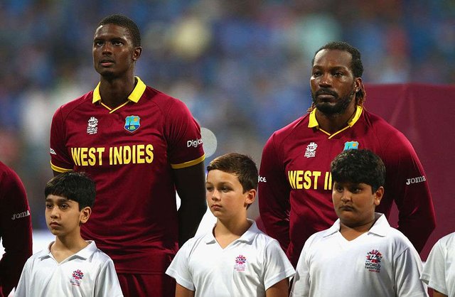 jason-holder-and-chris-gayle-of-the-west-indies-look-on-during-the-anthems-1499968196.jpg