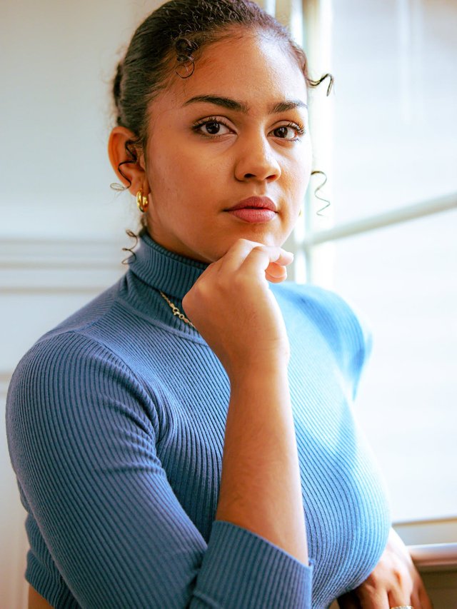free-photo-of-woman-wearing-blue-turtle-neck-posing-by-the-window.jpeg