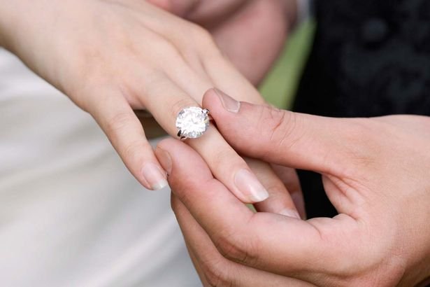 2018-03-11-31-06-Man-placing-diamond-ring-on-womans-finger.jpg