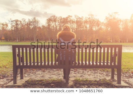 girl-sitting-on-lonely-bench-450w-1048651760.jpg