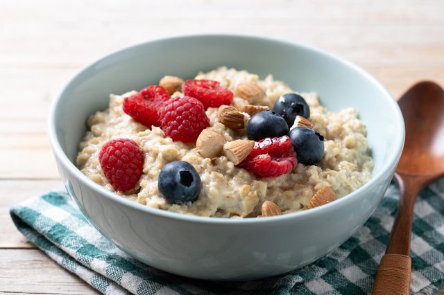 oatmeal-porridge-with-raspberries-blueberries-almonds-bowl-wooden-table_123827-32361.jpg