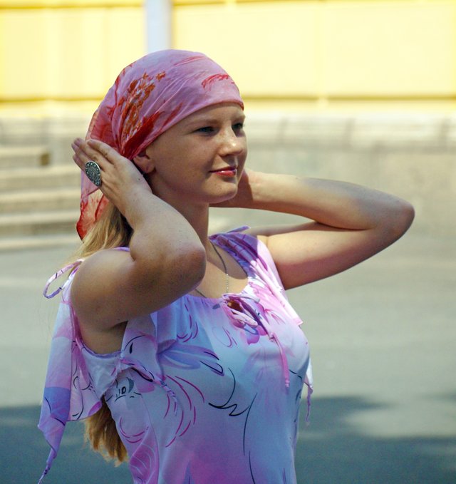 Russian_woman_putting_headscarf.jpg
