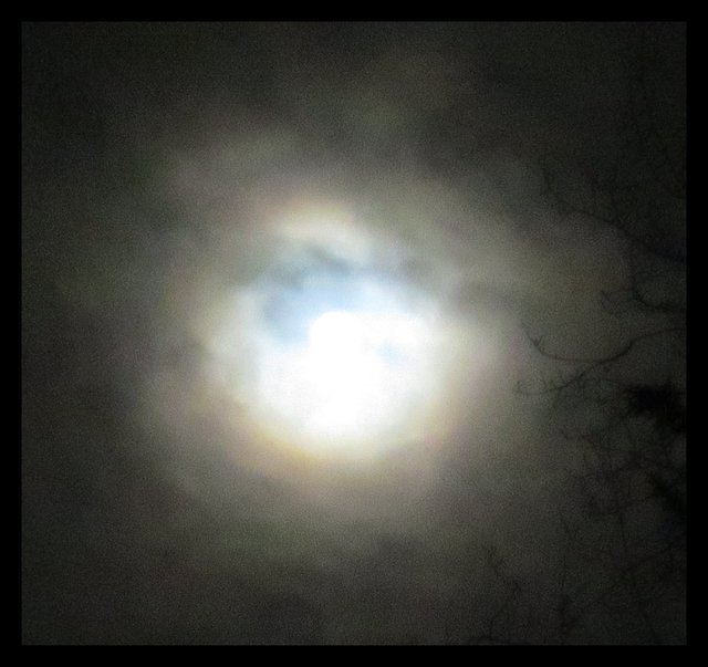 interesting light light clouds over full moon close up.JPG