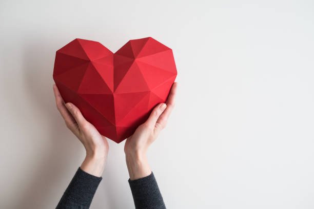 female-hands-holding-red-polygonal-heart-shape-picture-id641428170.jpeg