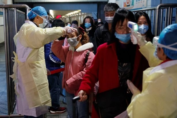 0_Medical-workers-take-the-temperature-of-passengers-after-they-got-off-the-train-in-Jiujiang.jpg