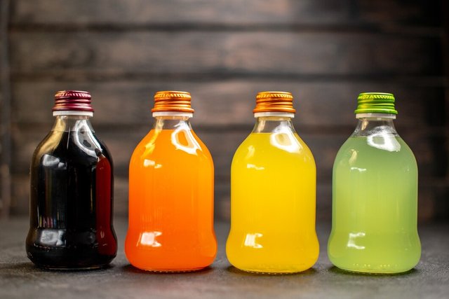 front-view-black-orange-yellow-green-fruit-juice-bottles_140725-99674.jpg