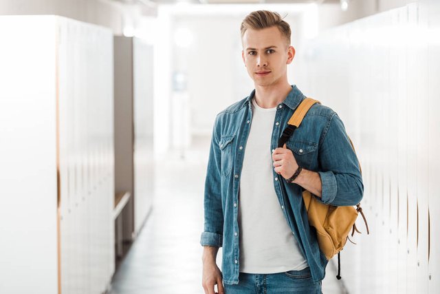 stock-photo-student-backpack-looking-camera-corridor.jpg