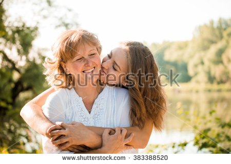 stock-photo-mature-mother-hugging-with-her-teen-daughter-outdoor-in-nature-on-sunny-day-383388520.jpg