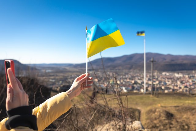 flag-ukraine-female-hands-against-sky.jpg
