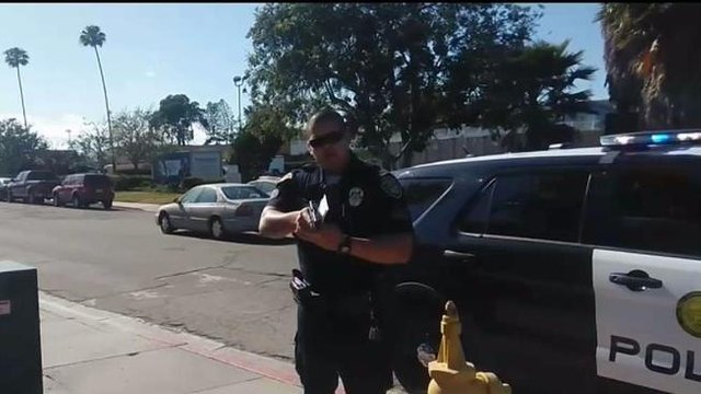 Mesa_College_Campus_Police_OfficerPoints_Gun_at_Photographer.jpg