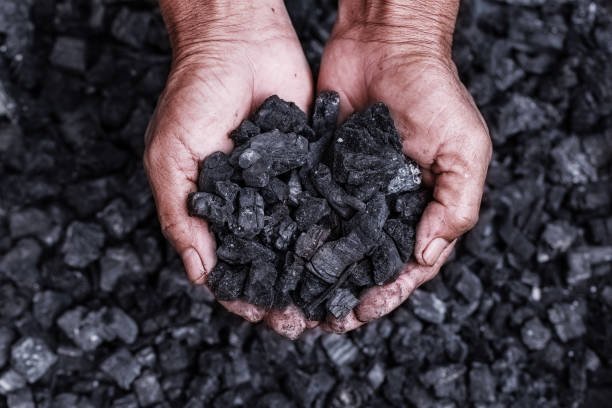 coal-mining-coal-miner-in-the-man-hands-of-coal-background-picture-idea-about-coal-mining-or.jpg