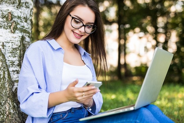 pretty-girl-blue-jeans-work-with-laptop-phone-citypark_231208-4224.jpg